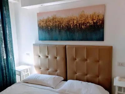 a bedroom with a bed and a painting on the wall at Pigneto Guest House in Rome