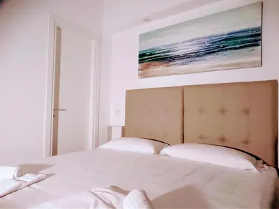 a bedroom with a bed with a painting on the wall at Pigneto Guest House in Rome