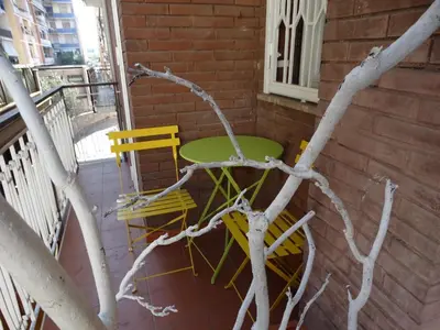 two chairs and a table on a balcony at Pigneto Guest House in Rome