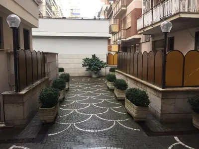 a courtyard with potted plants on the side of a building at Pigneto Guest House in Rome