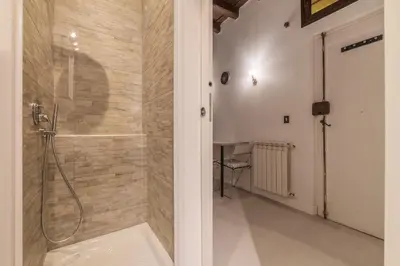 a bathroom with a shower with a glass door at GuestHost - Fori Imperiali Apartment in Rome