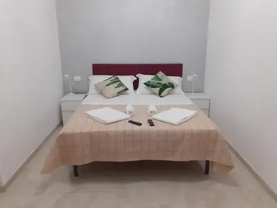 a bedroom with a bed with two pillows at ABID'S PALACE IN TERMINI in Rome