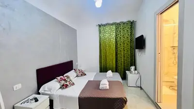 a small room with a bed and a window at ABID'S PALACE IN TERMINI in Rome