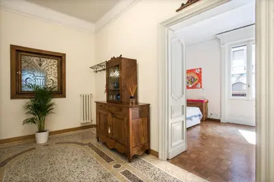 a room with a wooden dresser and a bedroom at Flat Two in Rome