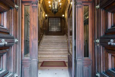 a hallway of a building with stairs and a chandelier at Flat Two in Rome