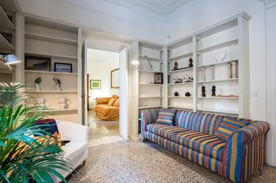 a living room with a couch and shelves at Flat Two in Rome