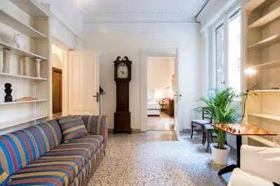 a living room with a couch and a grandfather clock at Flat Two in Rome
