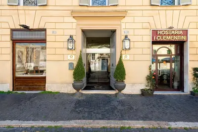 a store front of a building with two trees in front at Profumo Maison Colosseo in Rome