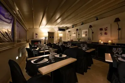 a restaurant with tables and chairs in a room at Profumo Maison Colosseo in Rome