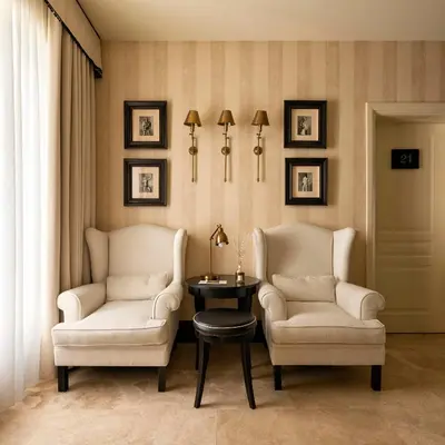 two chairs and a table in a room at Profumo Maison Colosseo in Rome