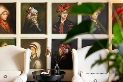 a room with paintings of people on a wall at Profumo Maison Colosseo in Rome
