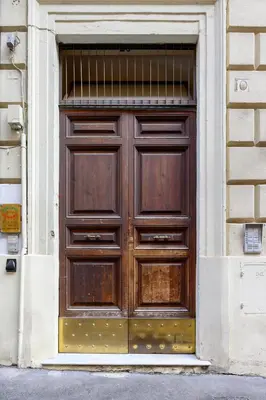 a large wooden door on the side of a building at Crosti Apartments in Rome