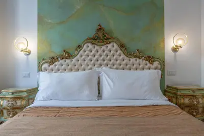 a bedroom with a large bed with white pillows at Palazzo Pamphili Lecca di Guevara in Rome