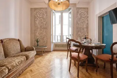 a living room with a couch and a table at Palazzo Pamphili Lecca di Guevara in Rome