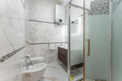 a bathroom with a shower and a sink and a toilet at Palazzo Pamphili Lecca di Guevara in Rome