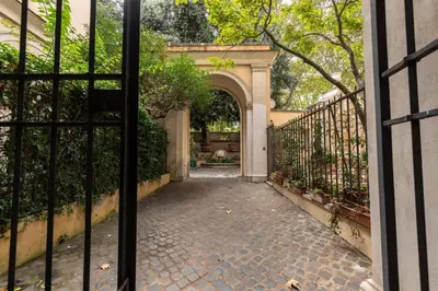 an entrance to a house with a gate and a courtyard at Palazzo Pamphili Lecca di Guevara in Rome