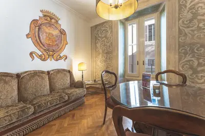 a living room with a couch and a table at Palazzo Pamphili Lecca di Guevara in Rome
