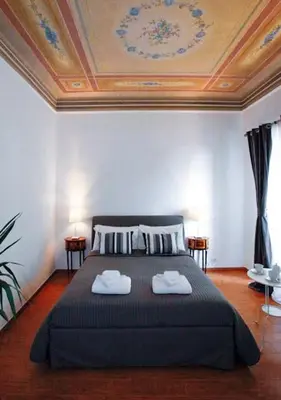a bedroom with a bed with two towels on it at Clemy In Rome in Rome