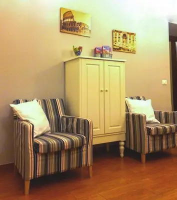 two chairs and a cabinet in a living room at Clemy In Rome in Rome