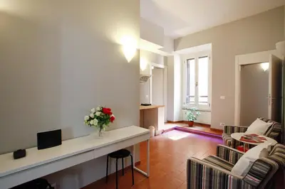 a living room with a vase of flowers on a counter at Clemy In Rome in Rome