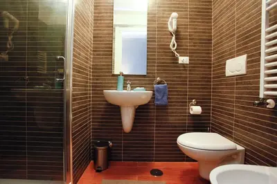 a bathroom with a sink and a toilet and a mirror at Clemy In Rome in Rome