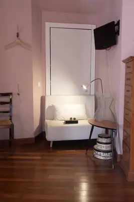 a bedroom with a white bed and a table at Suite Michelangelo in Rome