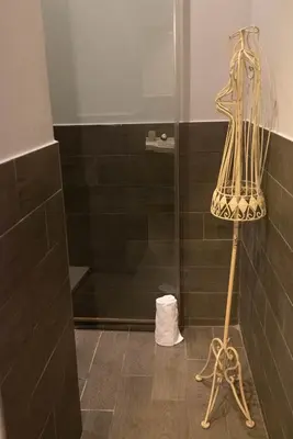 a shower in a bathroom with a glass shower stall at Suite Michelangelo in Rome