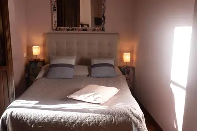 a bedroom with a bed with two pillows and a mirror at Suite Michelangelo in Rome