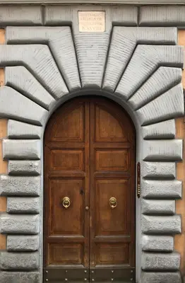 a wooden door in the middle of a building at Suite Michelangelo in Rome