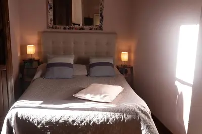 a bedroom with a bed with two pillows and a mirror at Suite Michelangelo in Rome