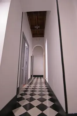a hallway with a black and white checkered floor at Trastevere 3 bedrooms in Rome