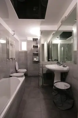 a bathroom with two sinks and a tub and two toilets at Trastevere 3 bedrooms in Rome