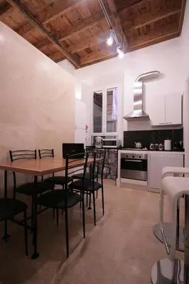 a kitchen and dining room with a table and chairs at Trastevere 3 bedrooms in Rome