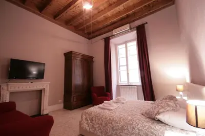 a bedroom with a bed and a tv and a fireplace at Trastevere 3 bedrooms in Rome