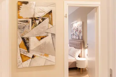 a bedroom with a painting on the wall next to a bed at Prati 25.7 Suites in Rome in Rome