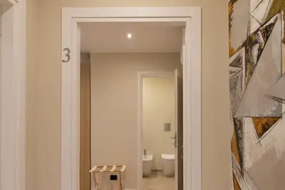 a corridor of a bathroom with a toilet and a doorway at Prati 25.7 Suites in Rome in Rome