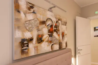 a painting hanging above a toilet in a room at Prati 25.7 Suites in Rome in Rome
