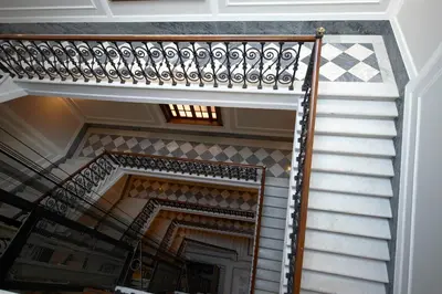 a stairway with a wooden railing and a stair case at Harry's Bar Trevi Luxury Apartments - Mignanelli in Rome