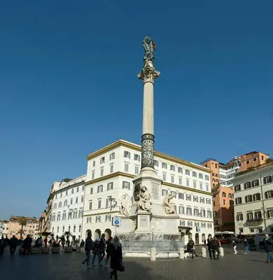 a statue in a square in front of a building at Harry's Bar Trevi Luxury Apartments - Mignanelli in Rome