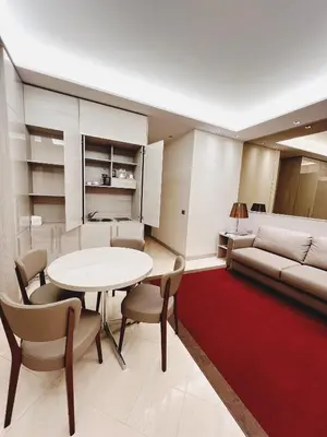a living room with a table and chairs and a couch at Harry's Bar Trevi Luxury Apartments - Mignanelli in Rome