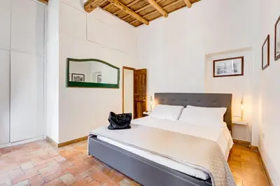 a bedroom with a bed and a mirror on the wall at LIVING COLOSSEUM in Rome