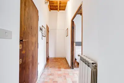 a hallway with a door and a brick floor at LIVING COLOSSEUM in Rome