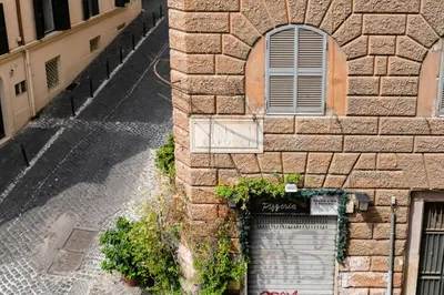 a stone building with a door and a window at LIVING COLOSSEUM in Rome