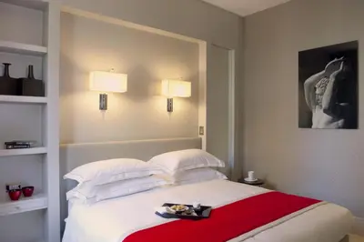 a bedroom with a white bed with a red blanket at Mood44 in Rome