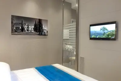 a bedroom with a bed and a tv on a wall at Mood44 in Rome