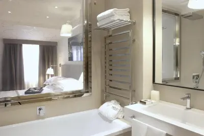 a bathroom with a tub and a sink and a mirror at Mood44 in Rome