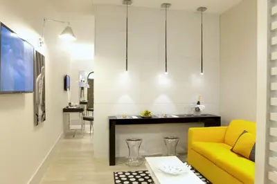a living room with a yellow couch and a table at Mood44 in Rome