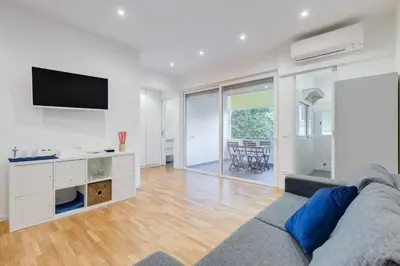 a living room with a couch and a tv at Giulio Cesare Apartment in Rome