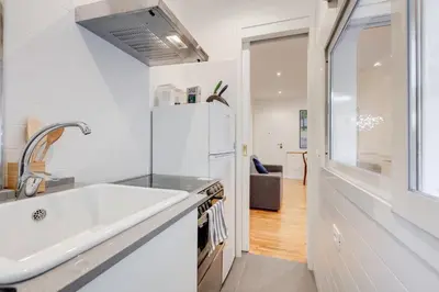 a kitchen with a sink and a refrigerator at Giulio Cesare Apartment in Rome