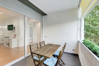 a dining room with a wooden table and chairs at Giulio Cesare Apartment in Rome
